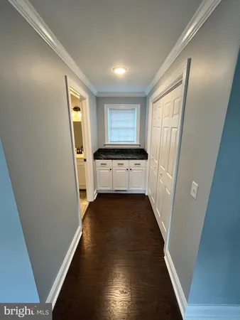 a view of a kitchen from a hallway