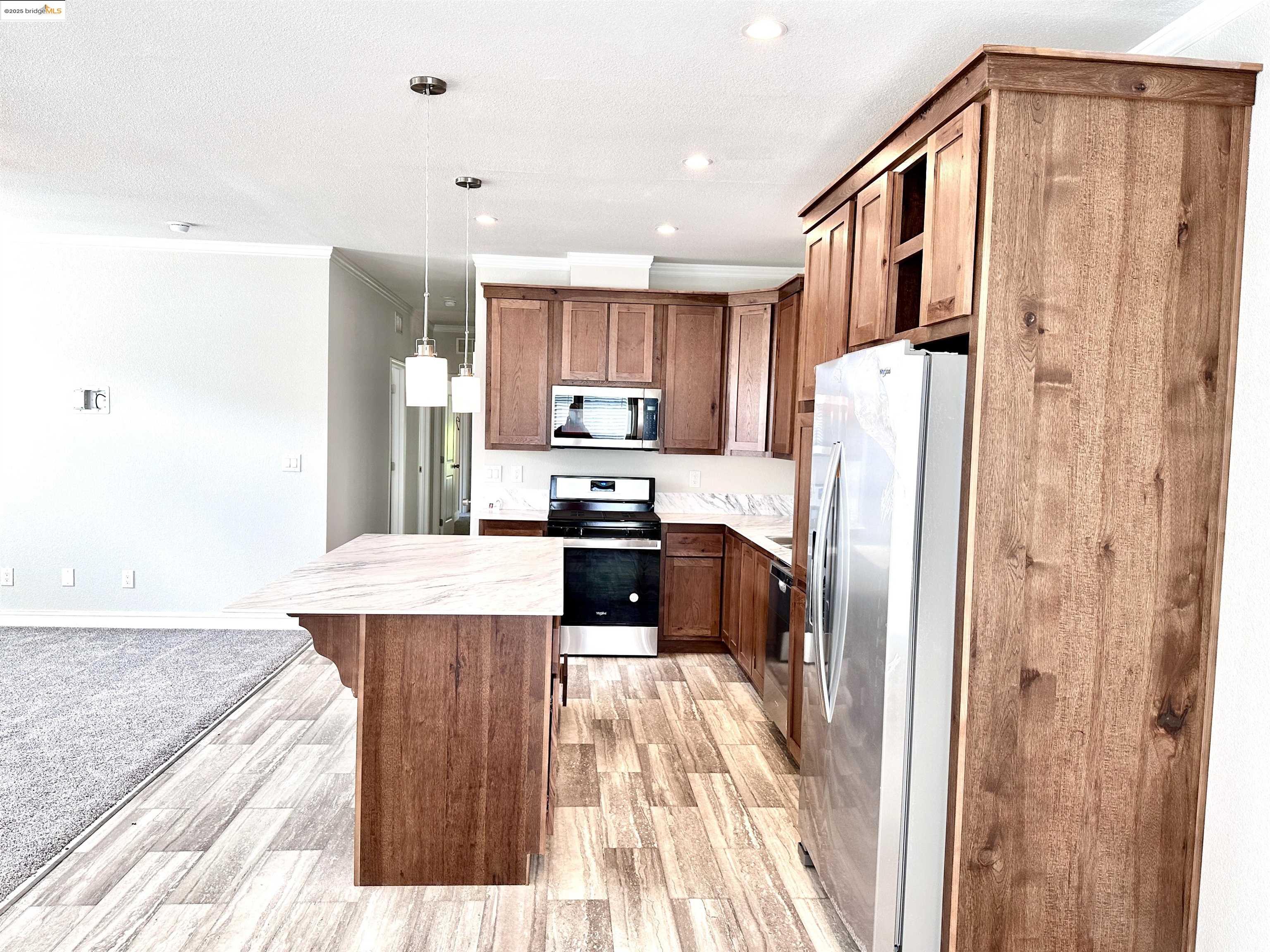 18330 Wards Ferry Road, Unit 25 Sonora, CA 95370 - Photo 12 of 22 a kitchen with stainless steel appliances a refrigerator and a stove