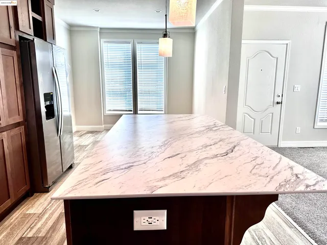 a bathroom with a granite countertop sink a toilet and shower