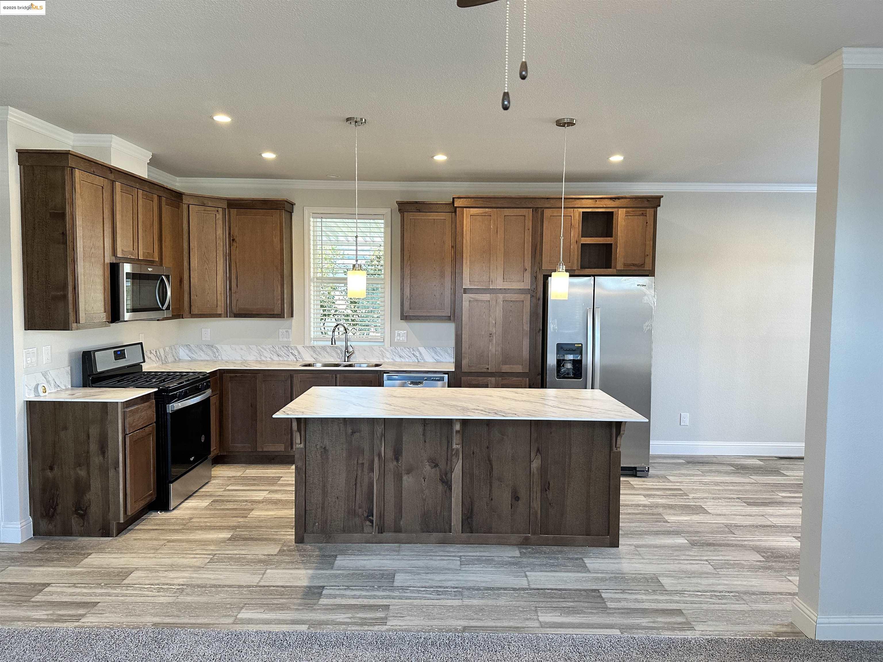 18330 Wards Ferry Road, Unit 25 Sonora, CA 95370 - Photo 5 of 22 a large kitchen with stainless steel appliances kitchen island granite countertop a sink and a stove