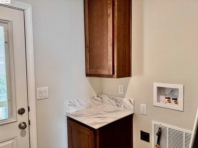 an empty room with a ceiling fan and a window