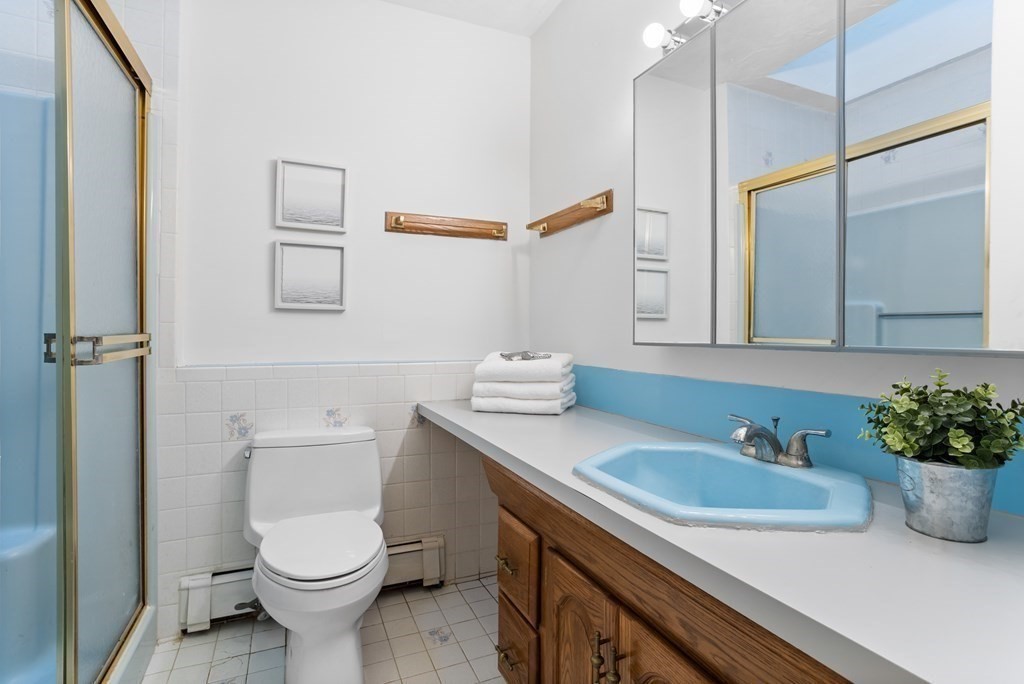 11 Patterson Road Lexington, MA 02421 - Photo 14 of 37 a bathroom with a sink a toilet and a mirror
