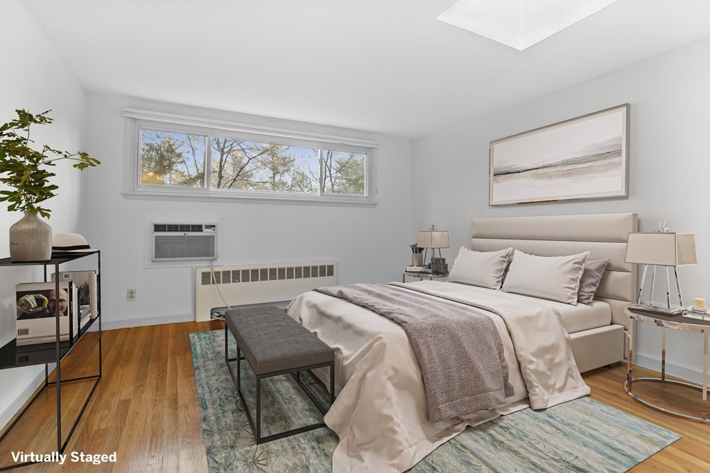 11 Patterson Road Lexington, MA 02421 - Photo 15 of 37 a bedroom with a bed and a table with wooden floor