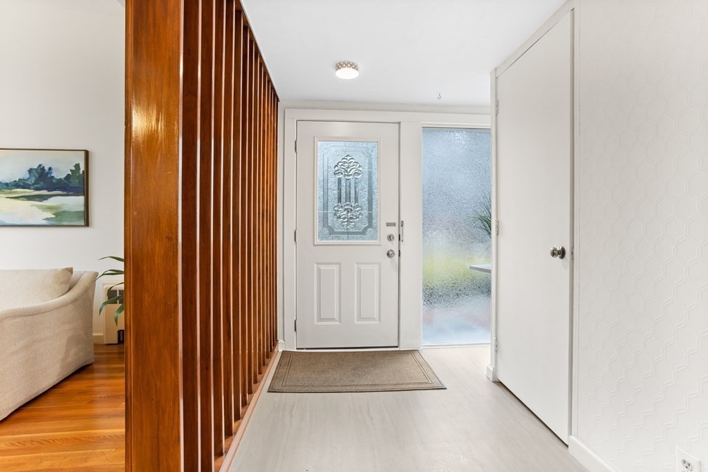 11 Patterson Road Lexington, MA 02421 - Photo 3 of 37 a view of a hallway with bathroom and wooden floor