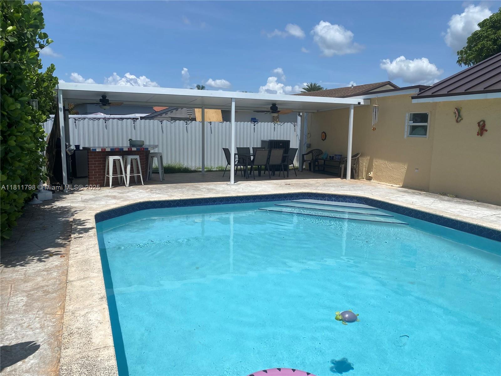 13360 Southwest 43rd Street Miami, FL 33175 - Photo 11 of 12 a view of a patio with table and chairs and potted plants