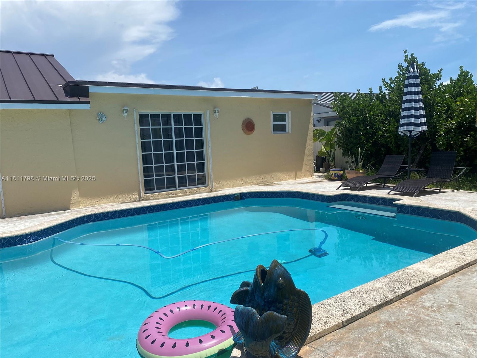 13360 Southwest 43rd Street Miami, FL 33175 - Photo 10 of 12 a backyard of a house with table and chairs