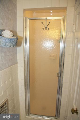 3601 Clifmar Road Windsor Mill, MD 21244 - Photo 15 of 30 a bathroom with a glass shower door and mirror