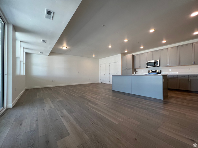 717 West W Coho Lane South, Unit 2F302 Midvale, UT 84047 - Photo 11 of 22 Open-concept living space featuring wood-finish flooring, recessed lighting, and a modern kitchen