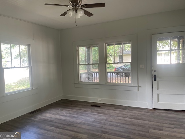 601 Nottingham Street Thomaston, GA 30286 - Photo 4 of 15 a view of an empty room with wooden floor and a window