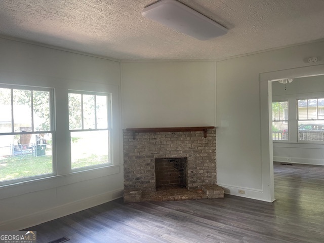 601 Nottingham Street Thomaston, GA 30286 - Photo 7 of 15 an empty room with wooden floor and a fireplace