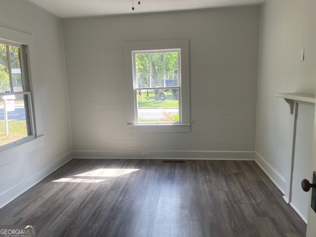 601 Nottingham Street Thomaston, GA 30286 - Photo 8 of 15 an empty room with wooden floor and windows