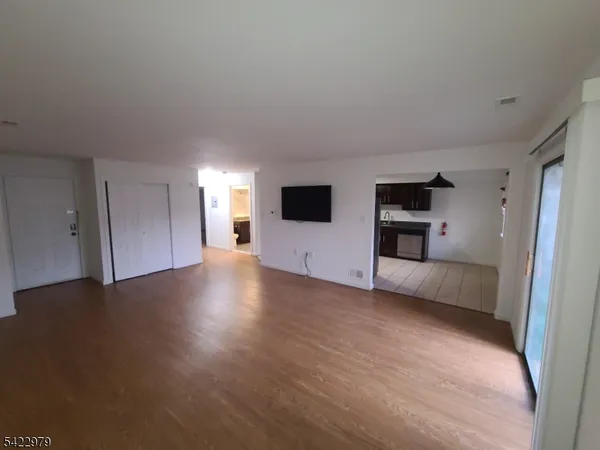 a view of a livingroom with an empty space and a fireplace