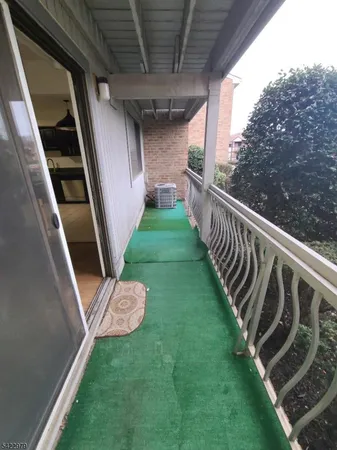 a view of a backyard with wooden fence and a stairs