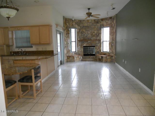 770 Schuster Road Southwest Palm Bay, FL 32908 - Photo 9 of 19 Kitchen and Fireplace