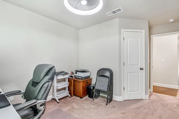 a view of a room with a piano and a chair
