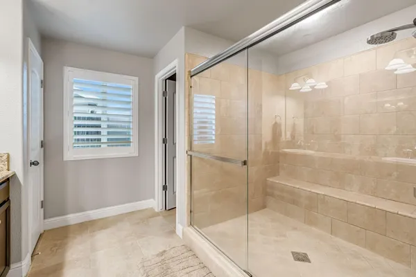 a bathroom with a shower and a bath tub