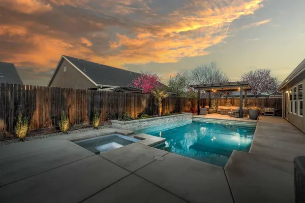 a swimming pool with barbeque oven outdoor seating