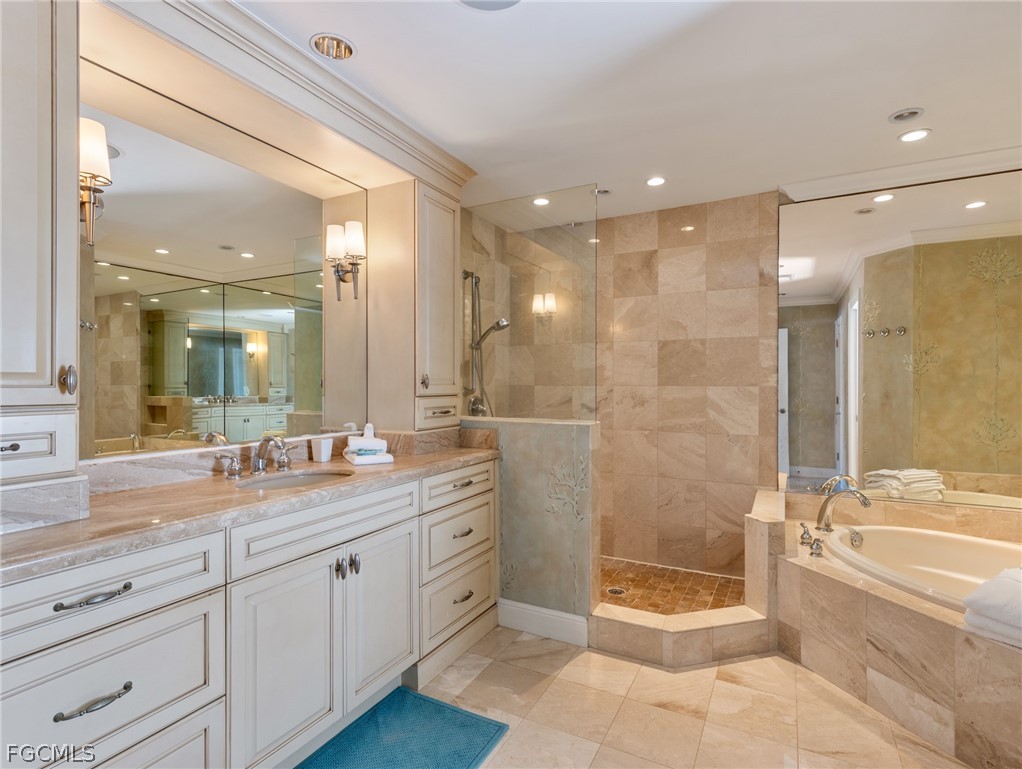 921 Prescott Street Fort Myers Beach, FL 33931 - Photo 27 of 50 a bathroom with a granite countertop sink a toilet a mirror and bathtub