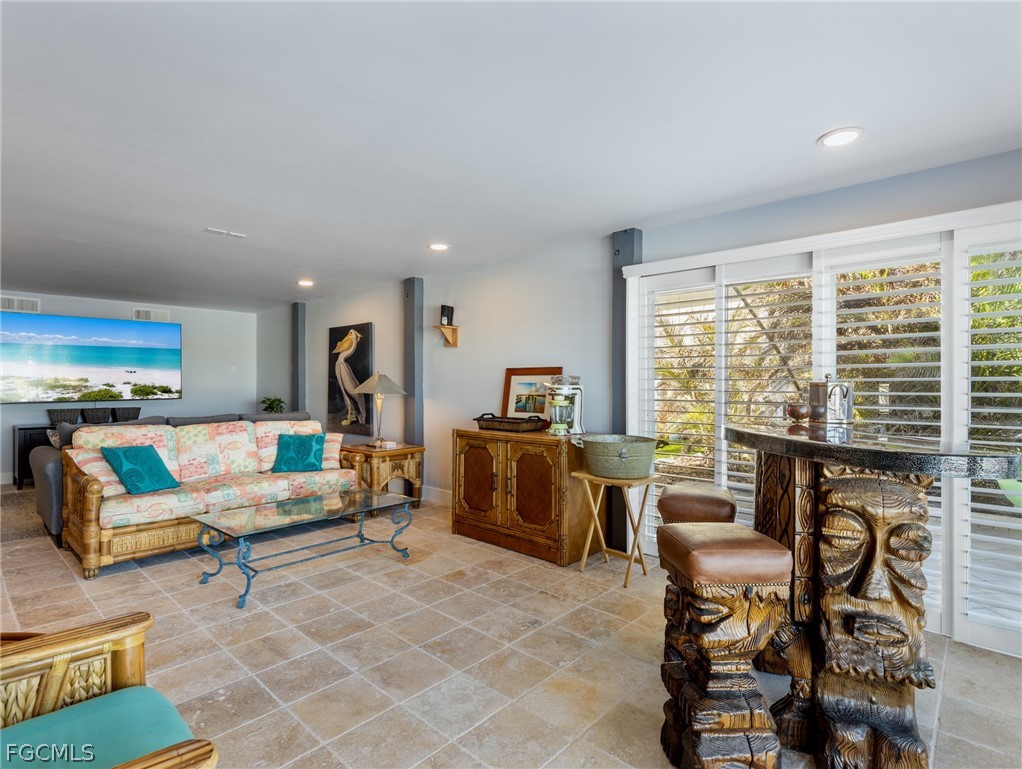 921 Prescott Street Fort Myers Beach, FL 33931 - Photo 32 of 50 a living room with furniture and a large window
