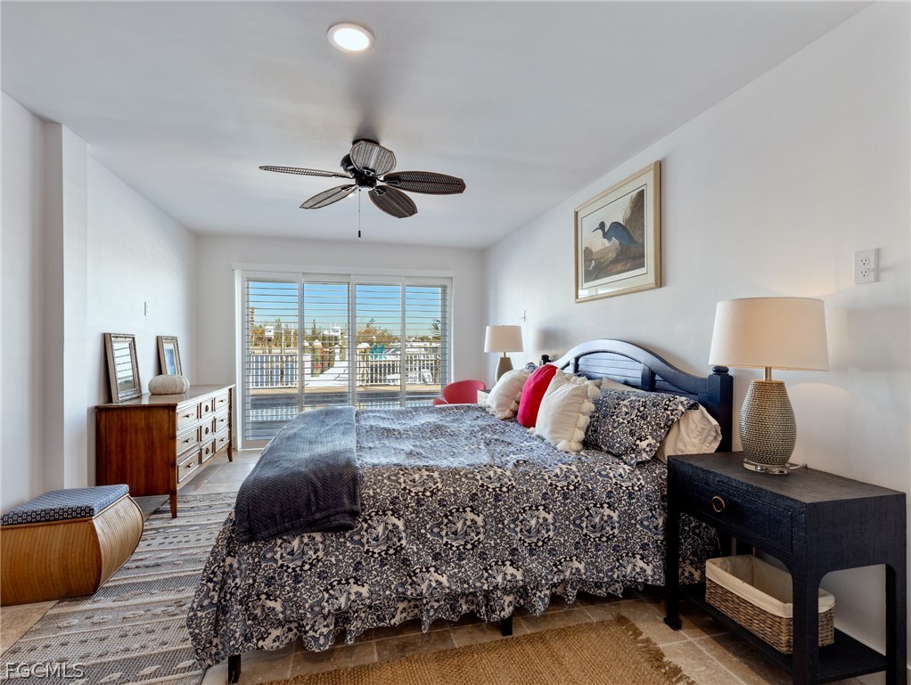 921 Prescott Street Fort Myers Beach, FL 33931 - Photo 33 of 50 a bedroom with a large bed and a window