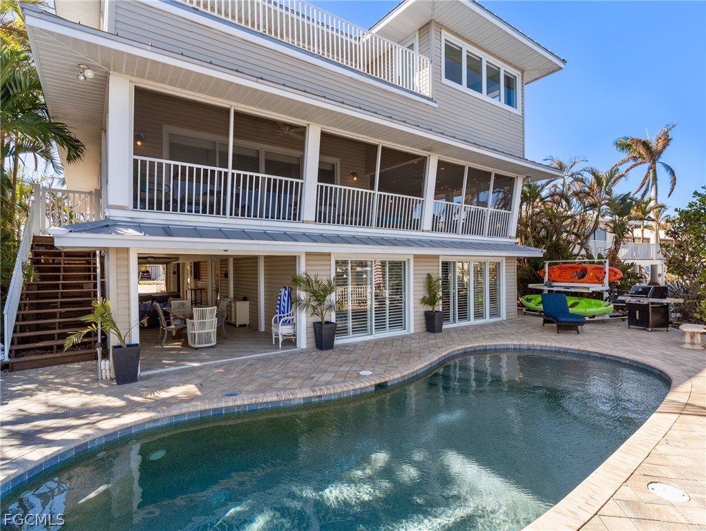 921 Prescott Street Fort Myers Beach, FL 33931 - Photo 37 of 50 a view of a house with swimming pool and sitting area