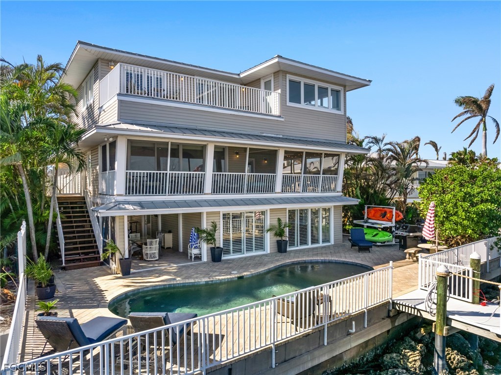921 Prescott Street Fort Myers Beach, FL 33931 - Photo 44 of 50 a front view of a house with a yard