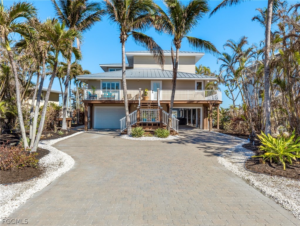 921 Prescott Street Fort Myers Beach, FL 33931 - Photo 50 of 50 a view of a house with a patio and a yard