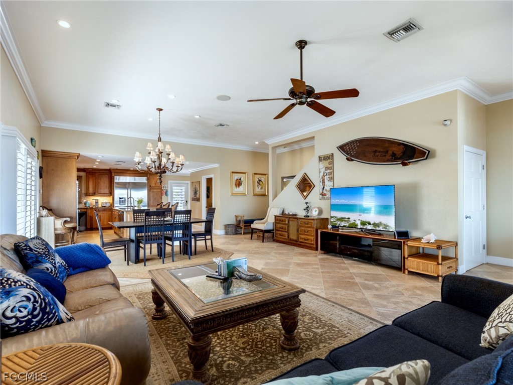 921 Prescott Street Fort Myers Beach, FL 33931 - Photo 9 of 50 a living room with furniture kitchen view and a chandelier