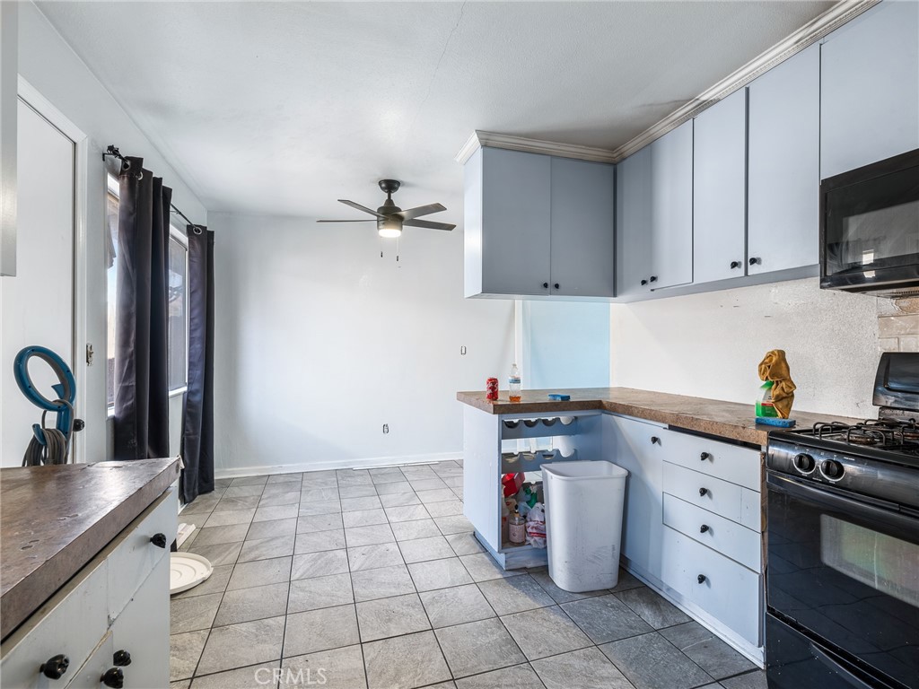 16003 Chestnut Street Hesperia, CA 92345 - Photo 11 of 28 a kitchen with granite countertop a stove a sink and a granite counter tops