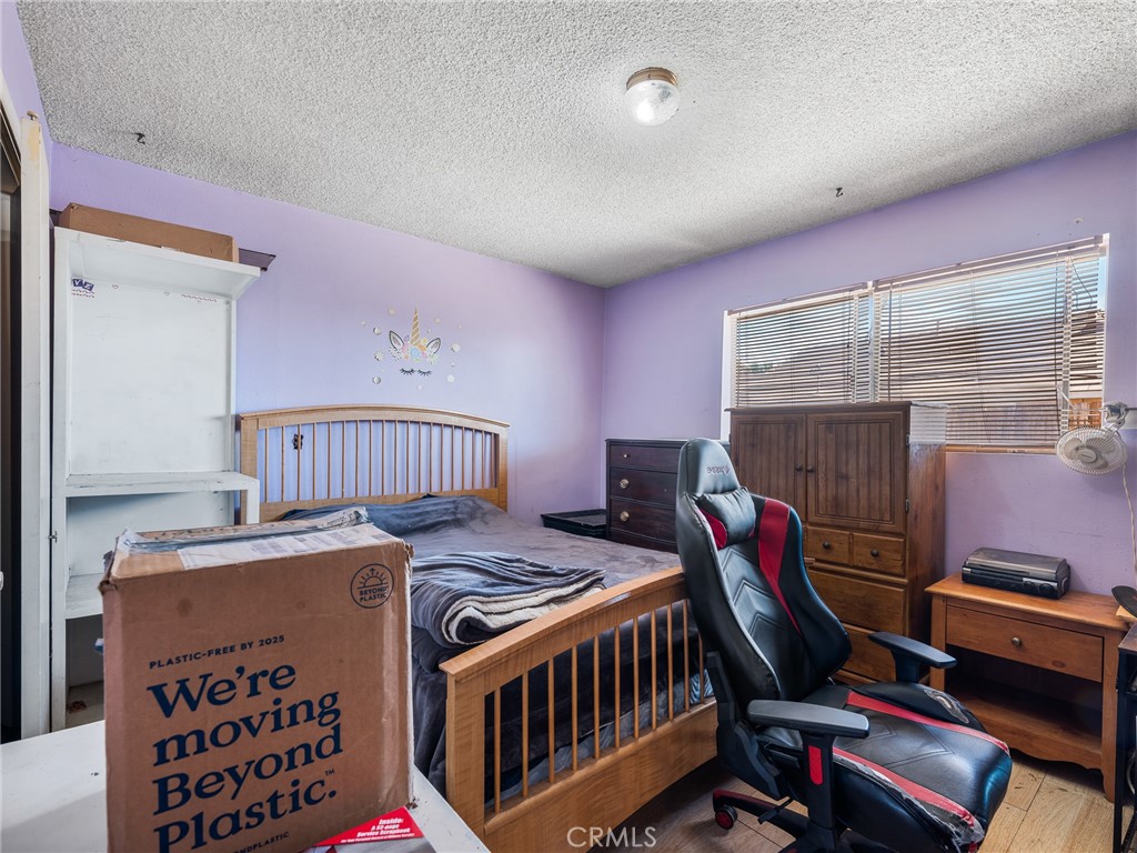 16003 Chestnut Street Hesperia, CA 92345 - Photo 14 of 28 a bedroom with furniture and a baby crib