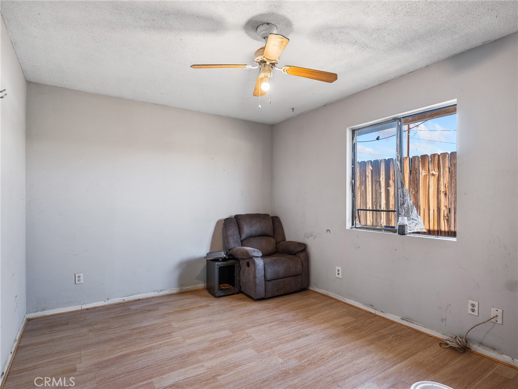16003 Chestnut Street Hesperia, CA 92345 - Photo 16 of 28 a view of wooden floor and windows in a room