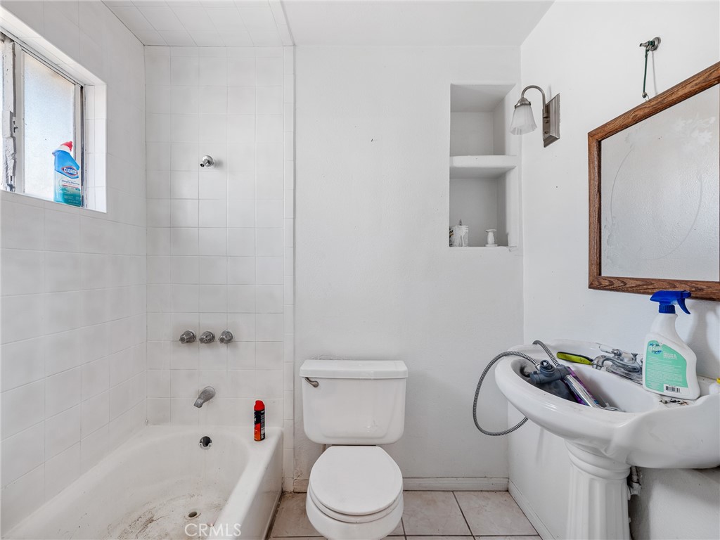 16003 Chestnut Street Hesperia, CA 92345 - Photo 18 of 28 a bathroom with a sink a toilet and a mirror