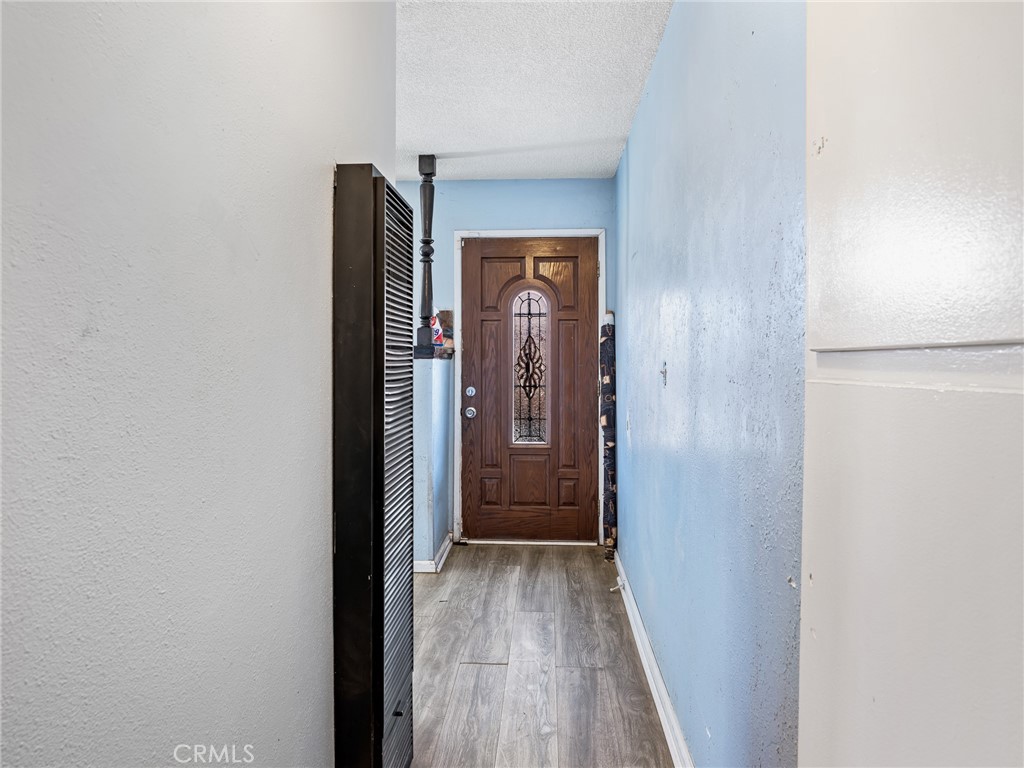 16003 Chestnut Street Hesperia, CA 92345 - Photo 5 of 28 a view of a hallway with wooden floor