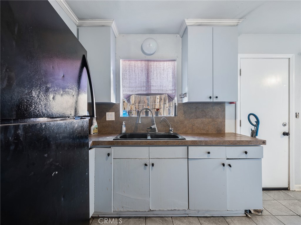 16003 Chestnut Street Hesperia, CA 92345 - Photo 10 of 28 a kitchen with white cabinets and sink