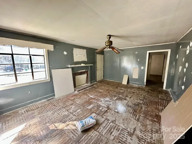 a view of a livingroom with a dishwasher and a large window