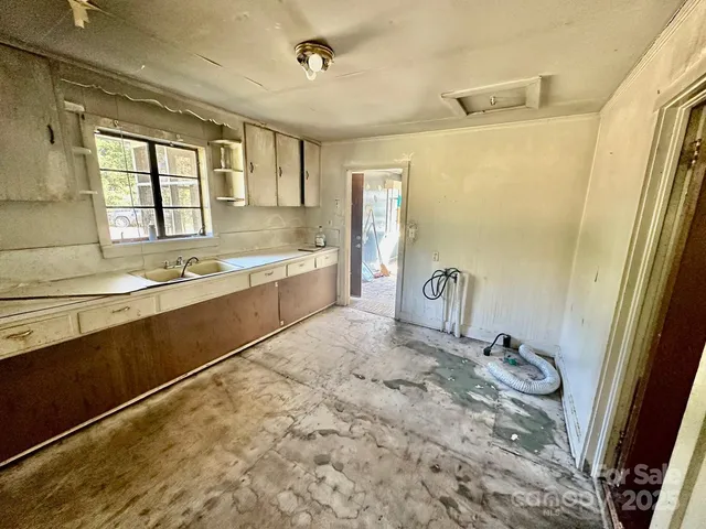 a spacious bathroom with a granite countertop sink and a bathtub
