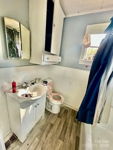 a bathroom with a sink mirror and a toilet