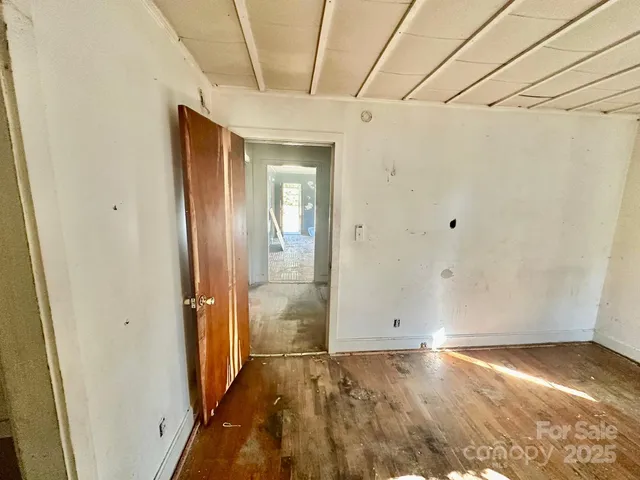 a view of a room with wooden floor