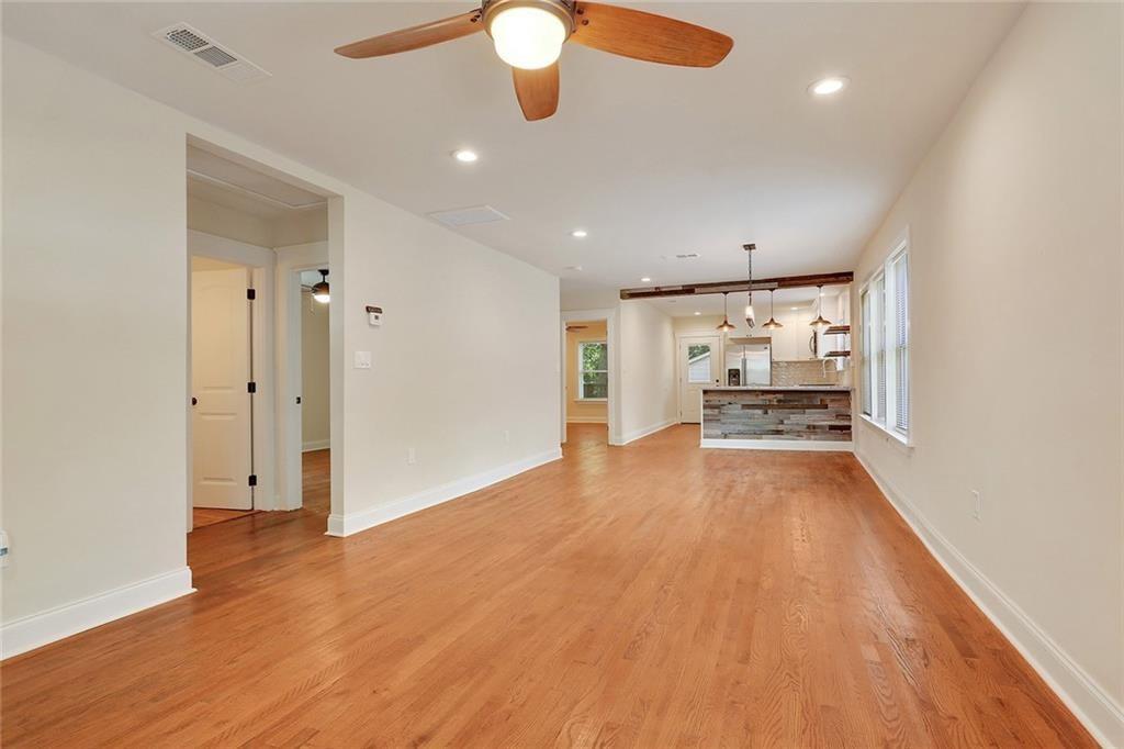 1060 Regent Street Southwest Atlanta, GA 30310 - Photo 1 of 24 an empty room with wooden floor and windows