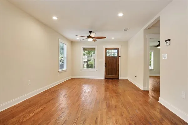 wooden floor in an empty room with a window