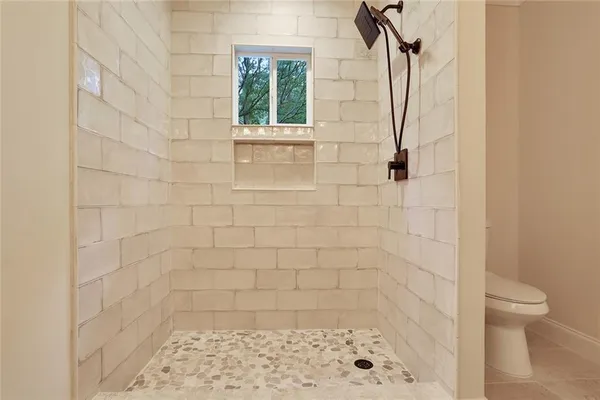 a bathroom with a shower and a toilet