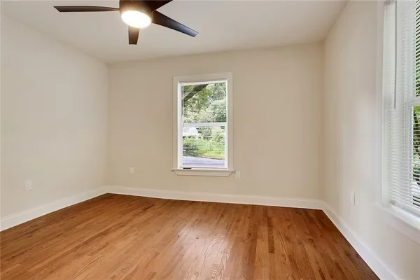 wooden floor in an empty room with a window