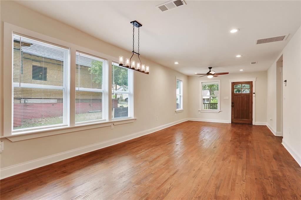 1060 Regent Street Southwest Atlanta, GA 30310 - Photo 4 of 24 a view of an empty room with a window and wooden floor