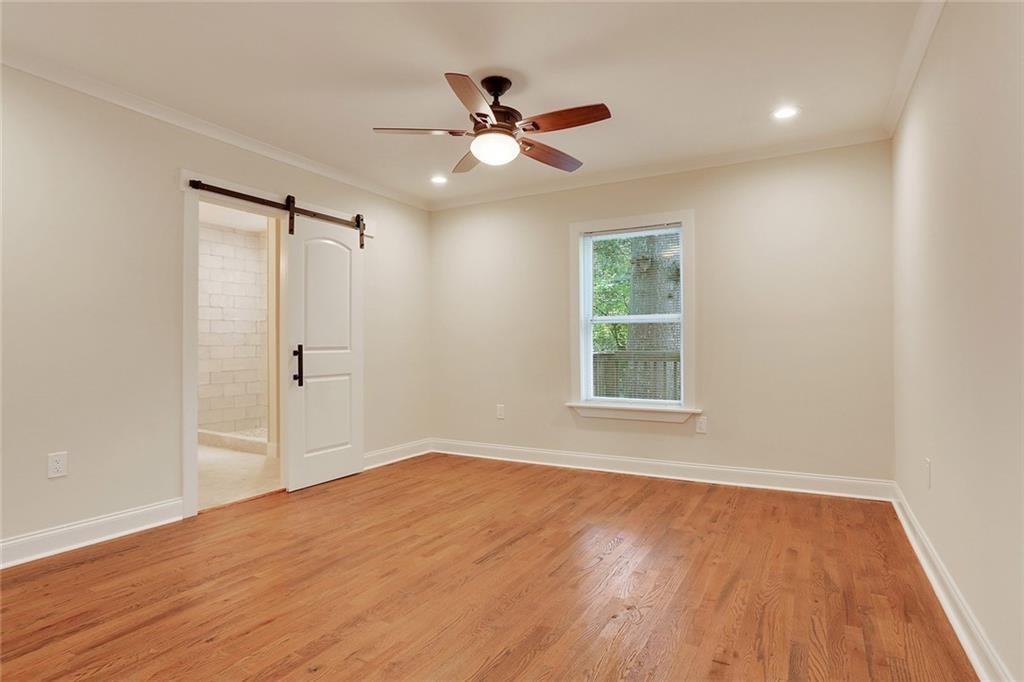 1060 Regent Street Southwest Atlanta, GA 30310 - Photo 5 of 24 a view of an empty room with wooden floor and a window
