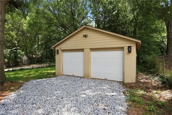 a view of backyard of house with large trees