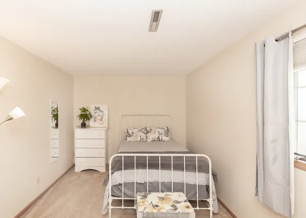 a bedroom with a bed and a window