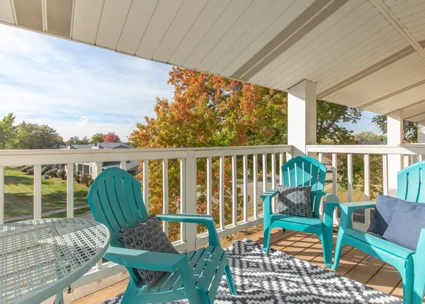a view of a chair and tables in the balcony