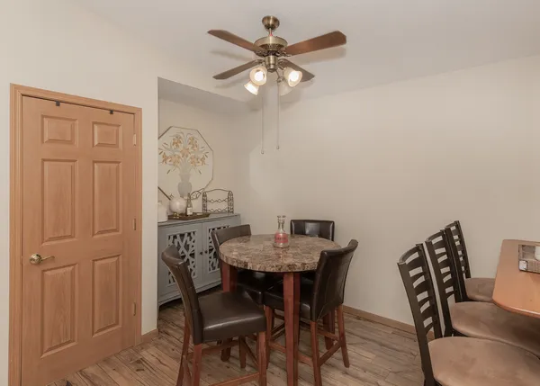 a view of a dining room with furniture and a chandelier fan