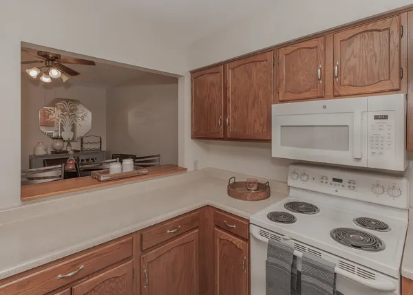 a kitchen with a cabinets and white appliances