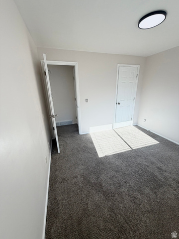 9571 David Street, Unit UPSTR Sandy, UT 84070 - Photo 13 of 13 Spacious carpeted bedroom with dual closet storage, recessed ceiling lighting, and bright natural light from multiple windows